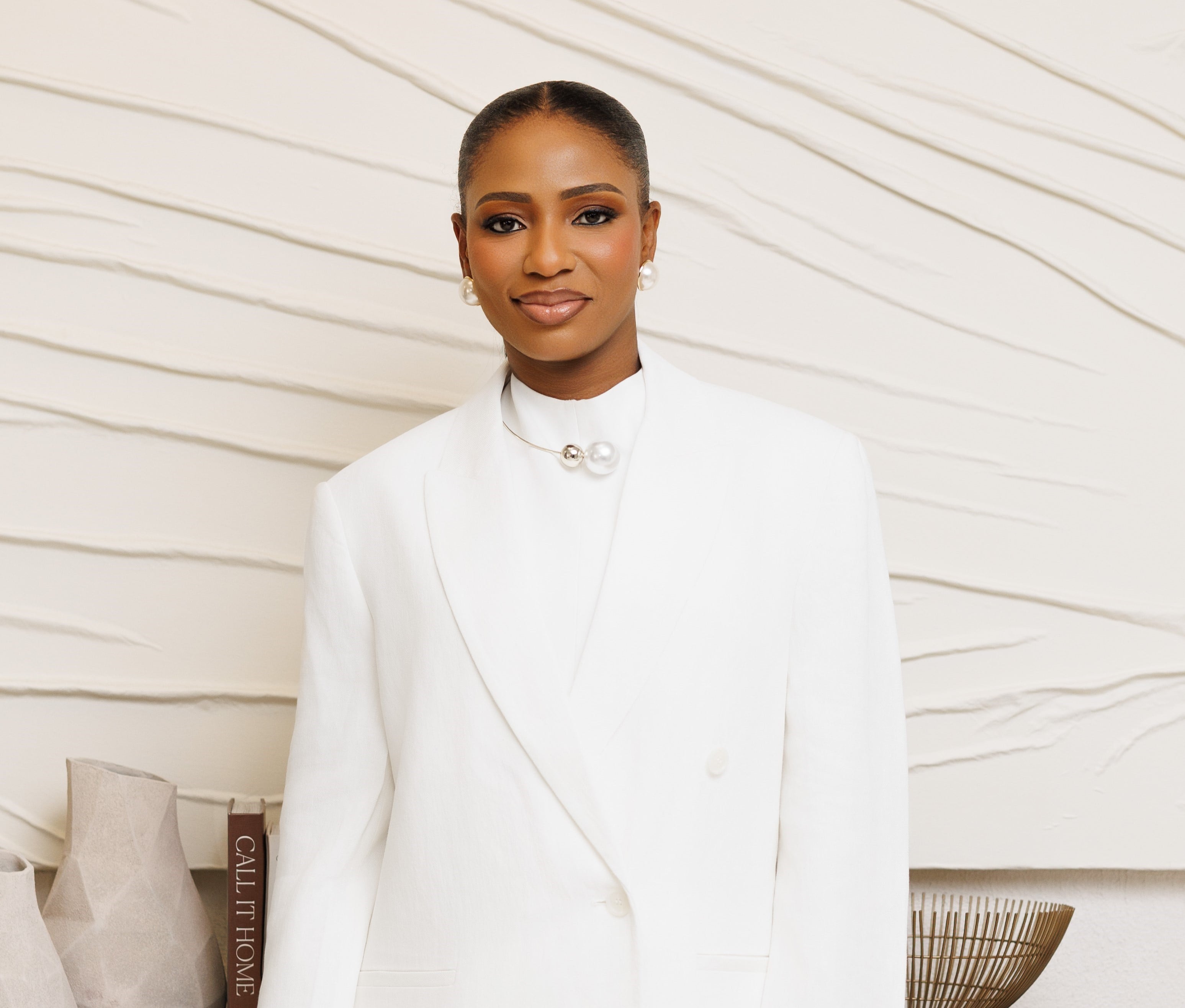 Omotayo Senbore, founder of NeuroKids Allies, dressed in an elegant white blazer